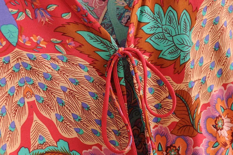 Close-up of a colorful fabric with floral and abstract patterns.