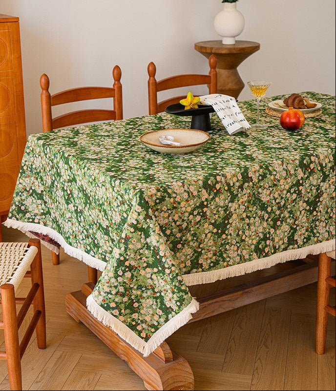 Table set with a floral tablecloth in a room with wooden furniture.