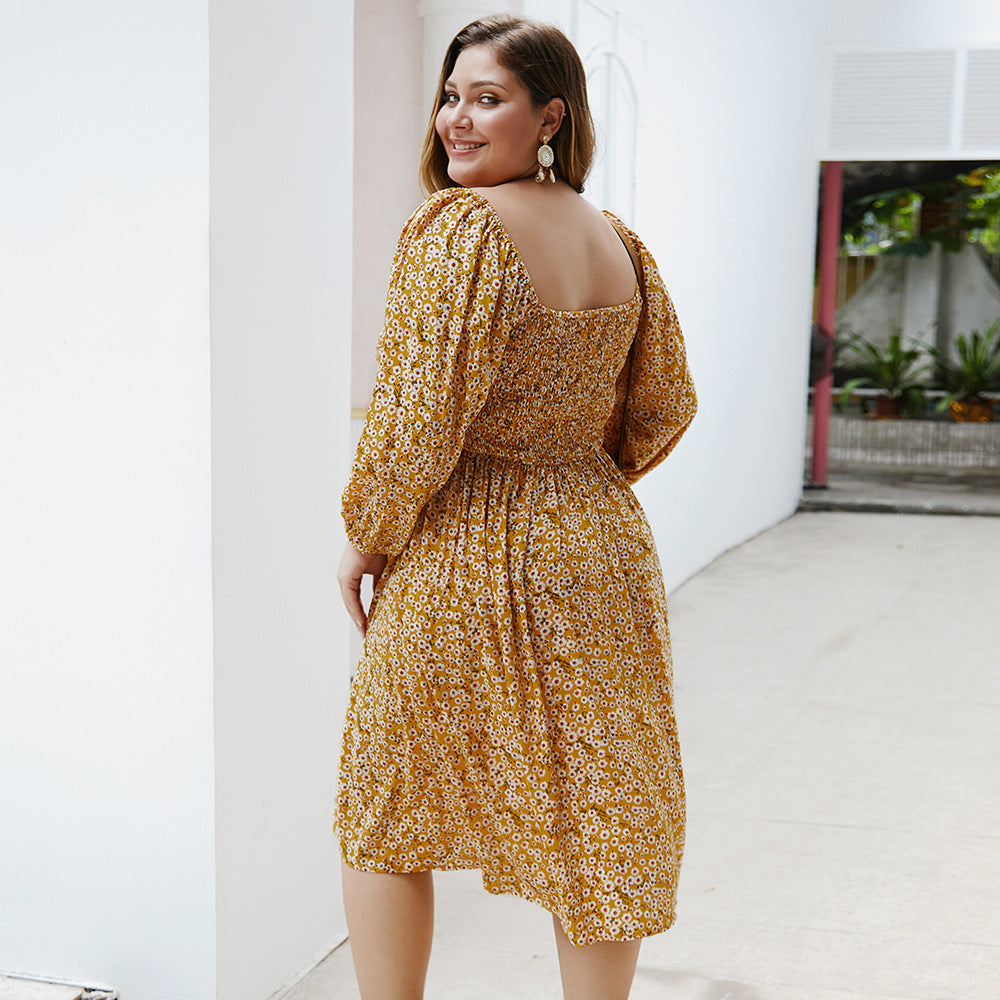 Woman wearing a yellow floral dress in an indoor setting
