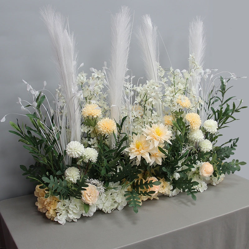 Floral arrangement with white and yellow flowers on a gray surface