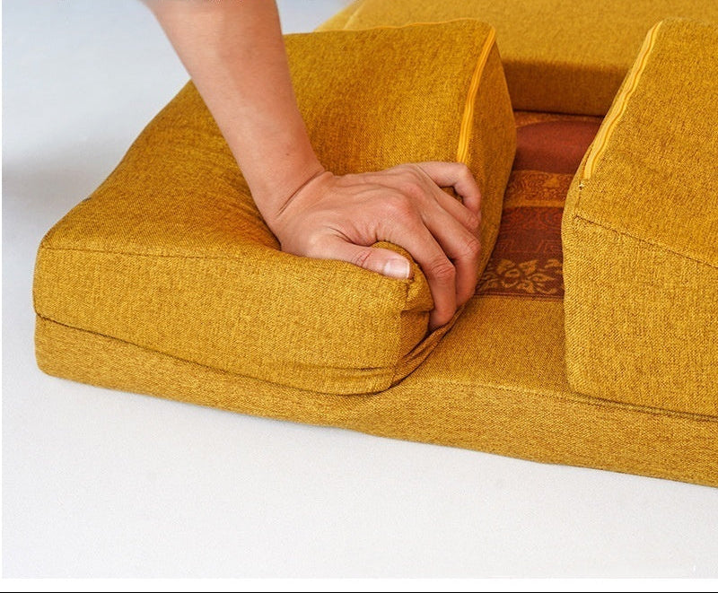 Yellow cushion with a hand pressing into it, highlighting high-resilience sponge core material.