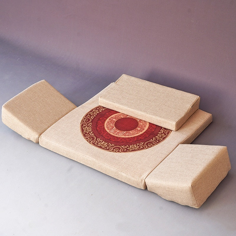 Foldable beige cushion with a red and gold circular design on a gray background