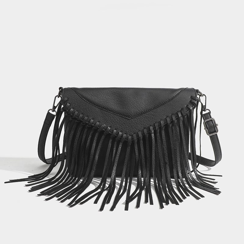 Black fringe handbag on a light gray background