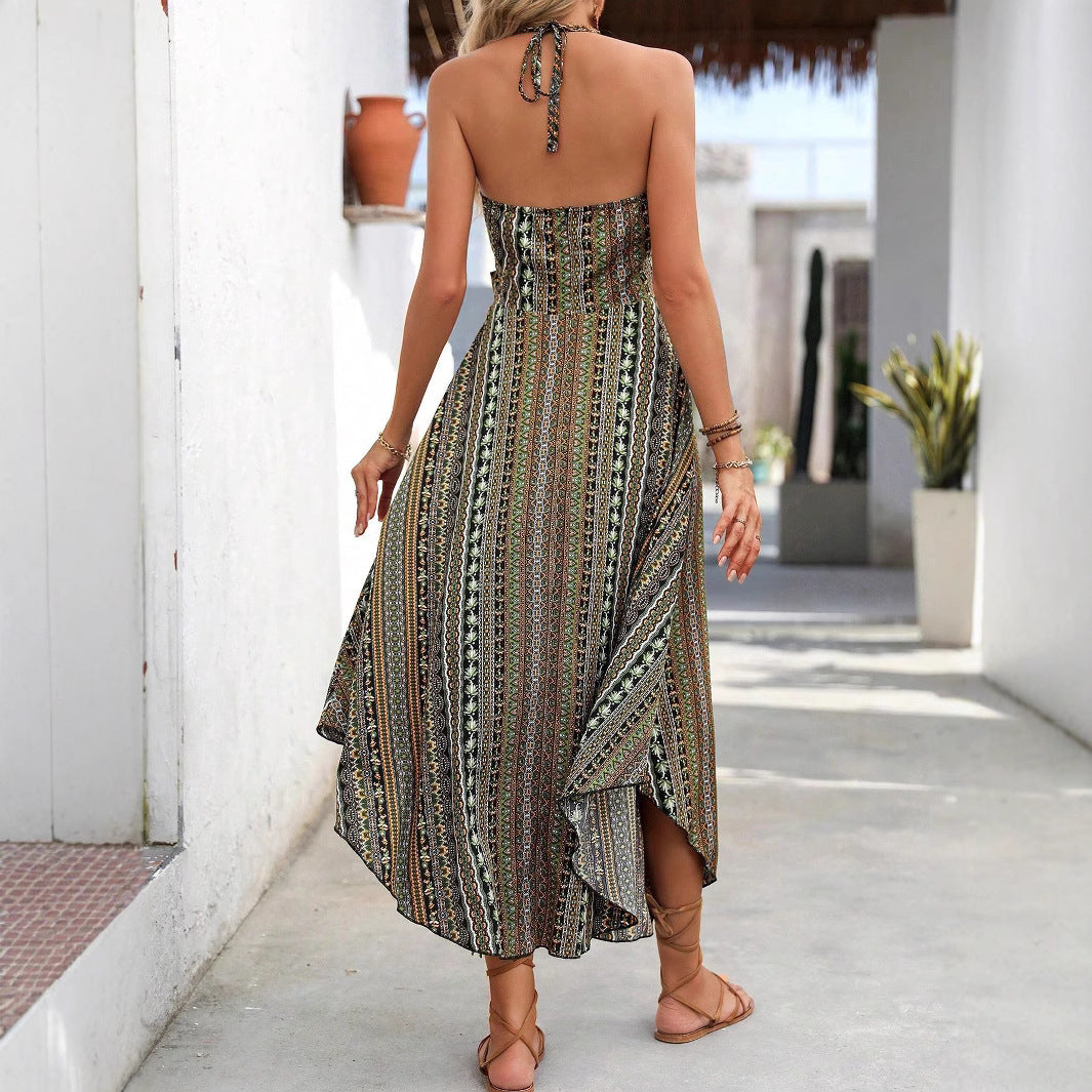 Woman wearing a patterned dress walking on a sunlit path.