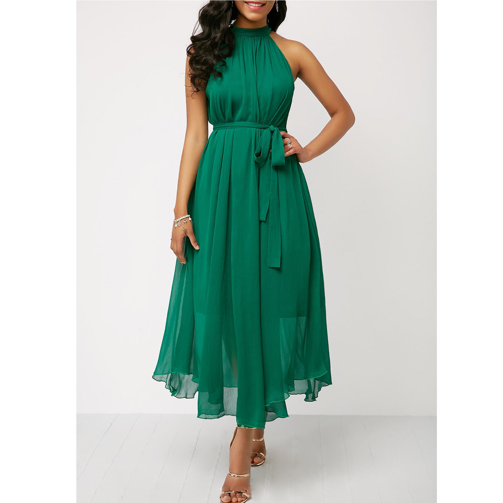Green dress worn by a model on a white background