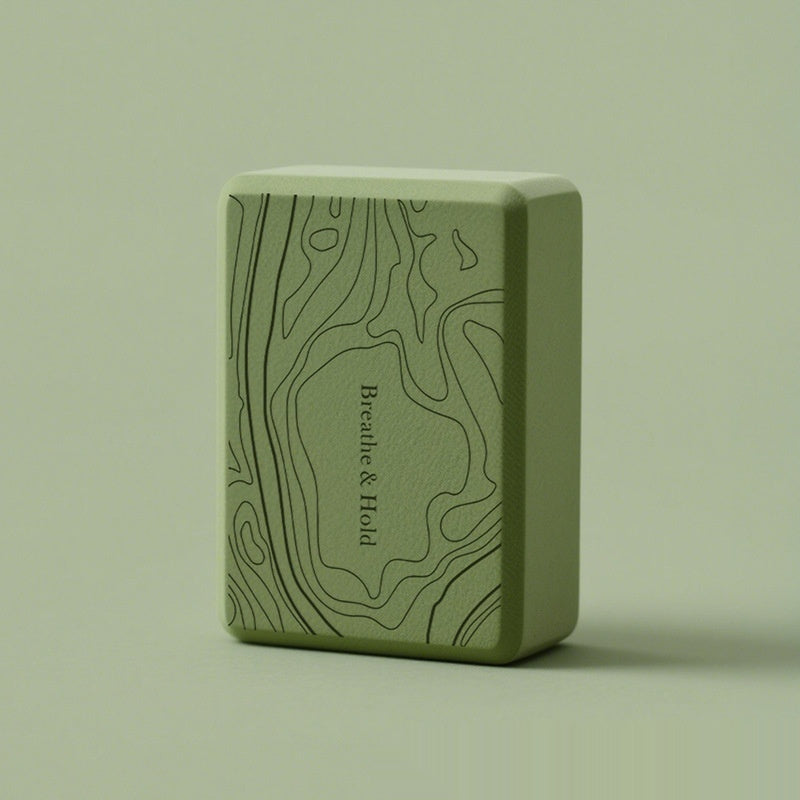 Green yoga block with 'Breathe & Hold' text on a matching background
