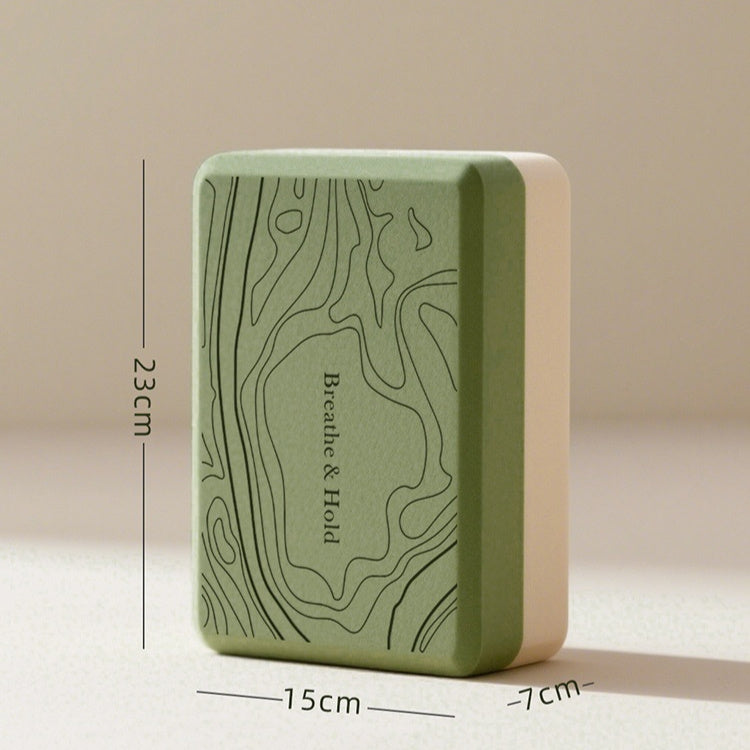 Green yoga block with measurements on a beige background
