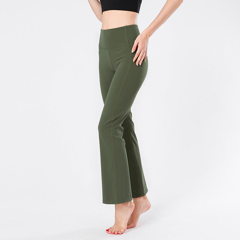 Green flared pants worn by a person on a white background