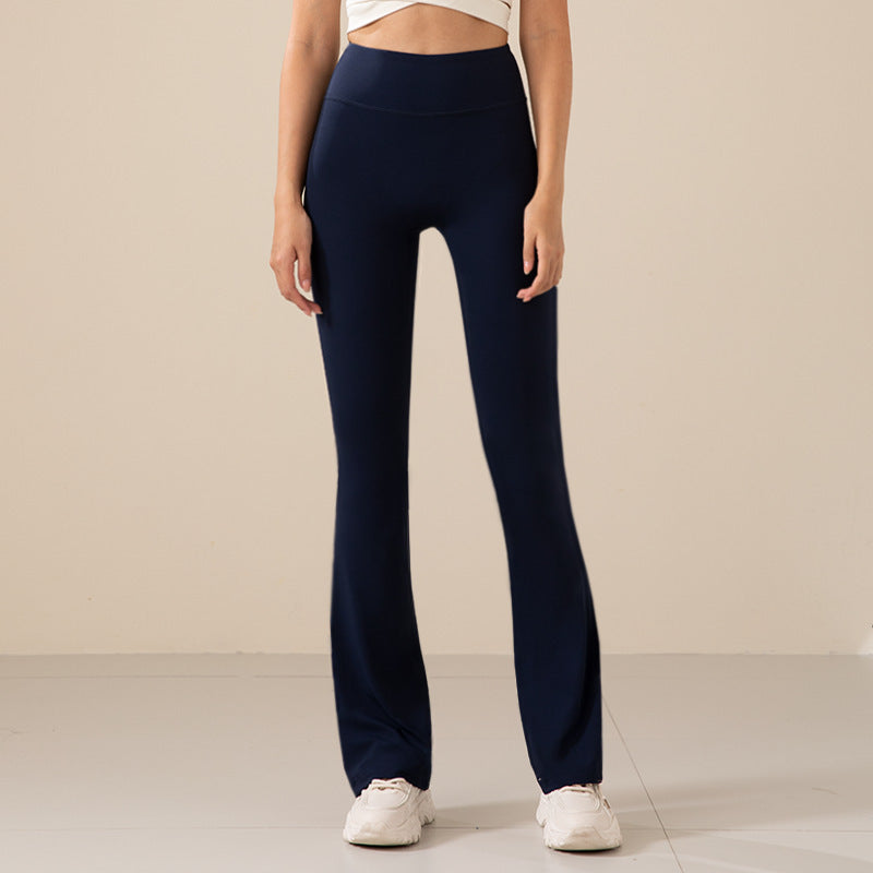 Person wearing navy blue pants on a plain background