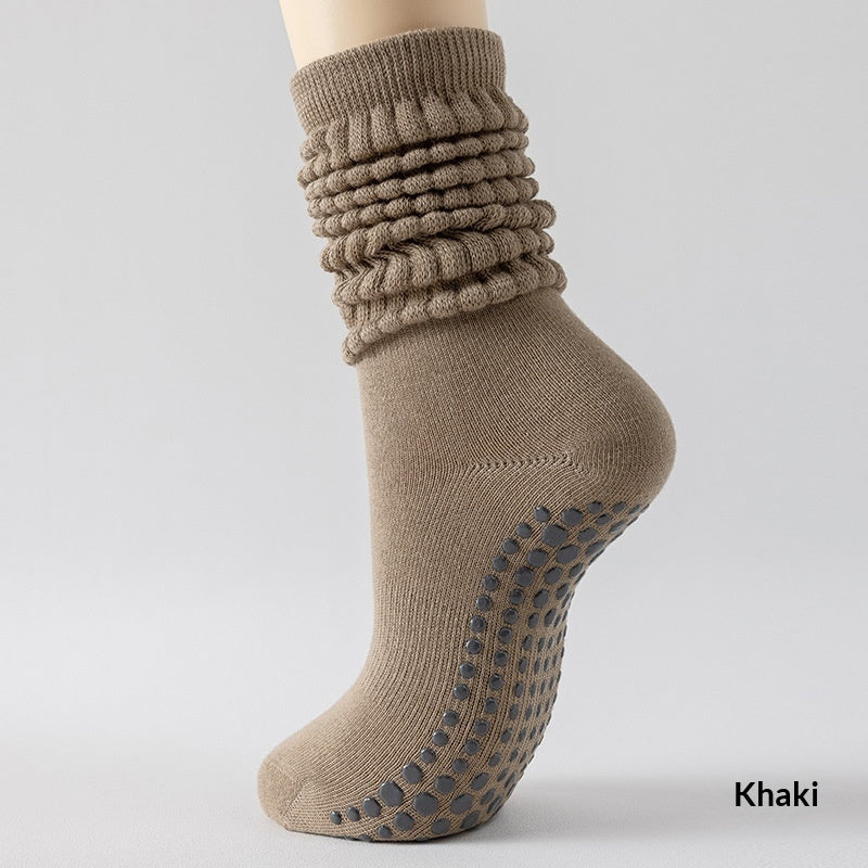 Khaki sock with textured top and non-slip sole on a light gray background