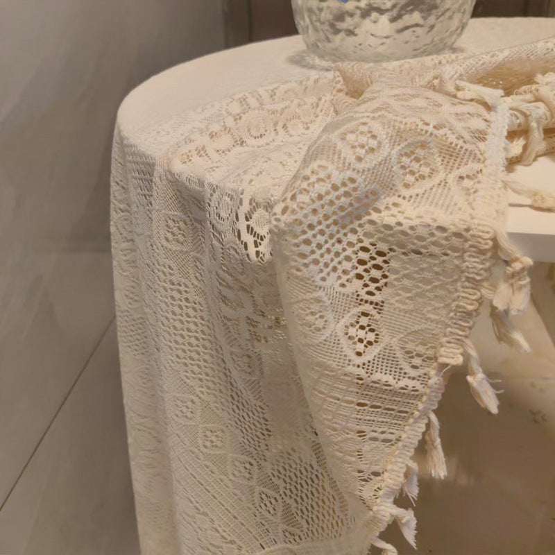 Lace tablecloth draped over a table with a neutral background