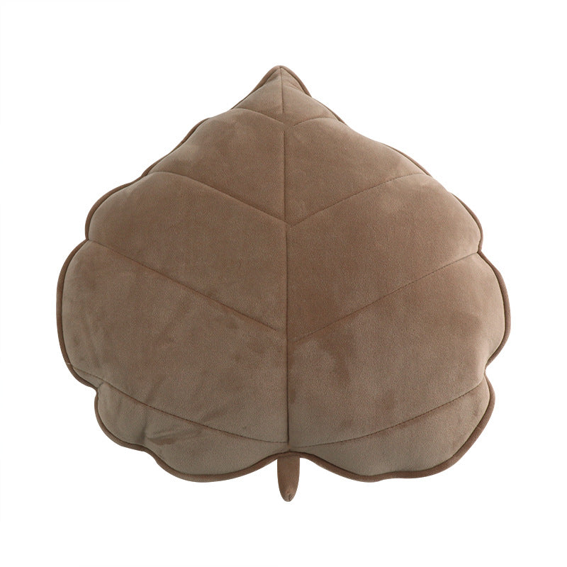 Brown leaf-shaped cushion on a white background