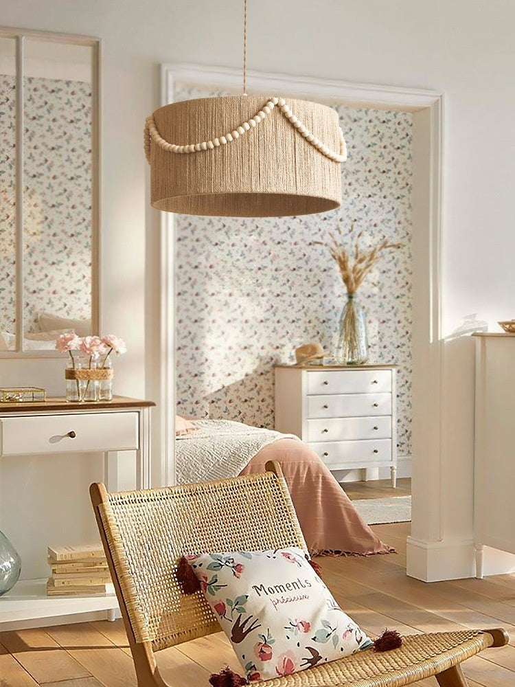 Living room with wicker chair, floral pillow, and decorative elements.