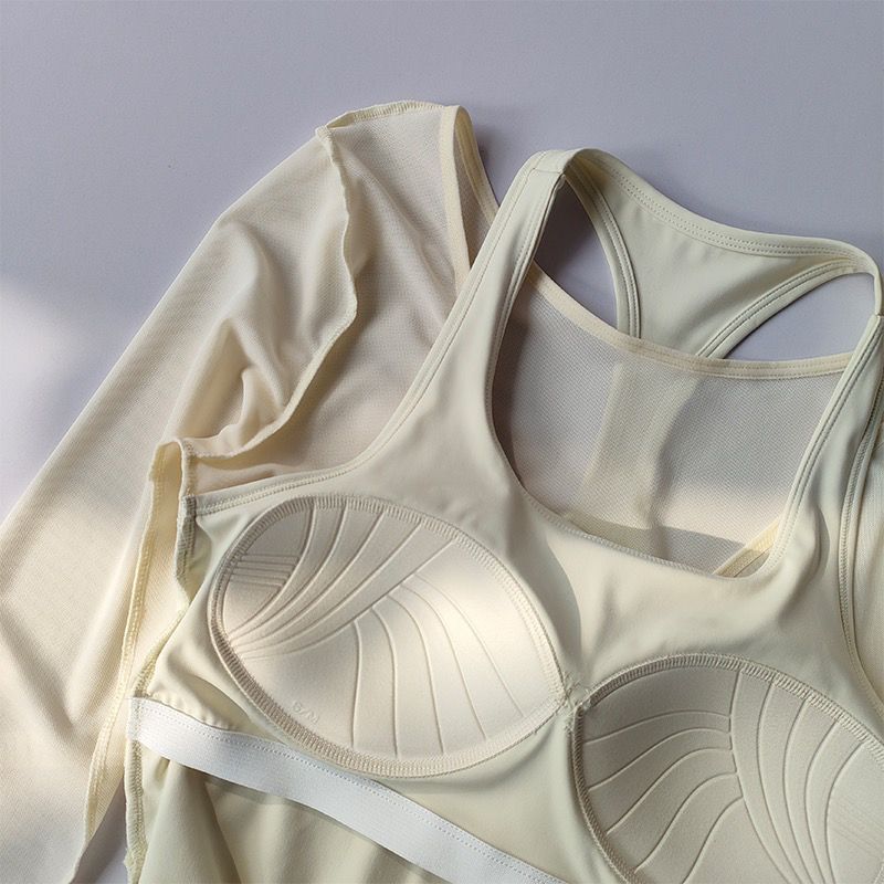 Beige bra and tank top set on a light gray background