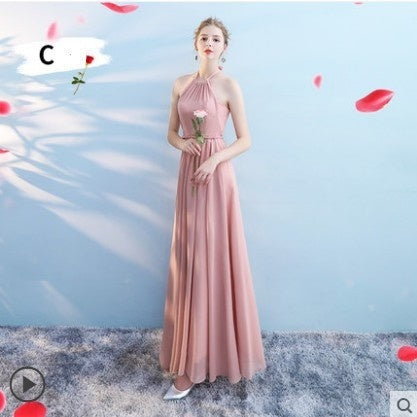 Woman in a long pink dress holding a rose against a light blue background with red flower petals.