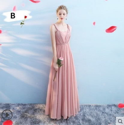 Woman in a pink dress against a light blue background with red flower petals.