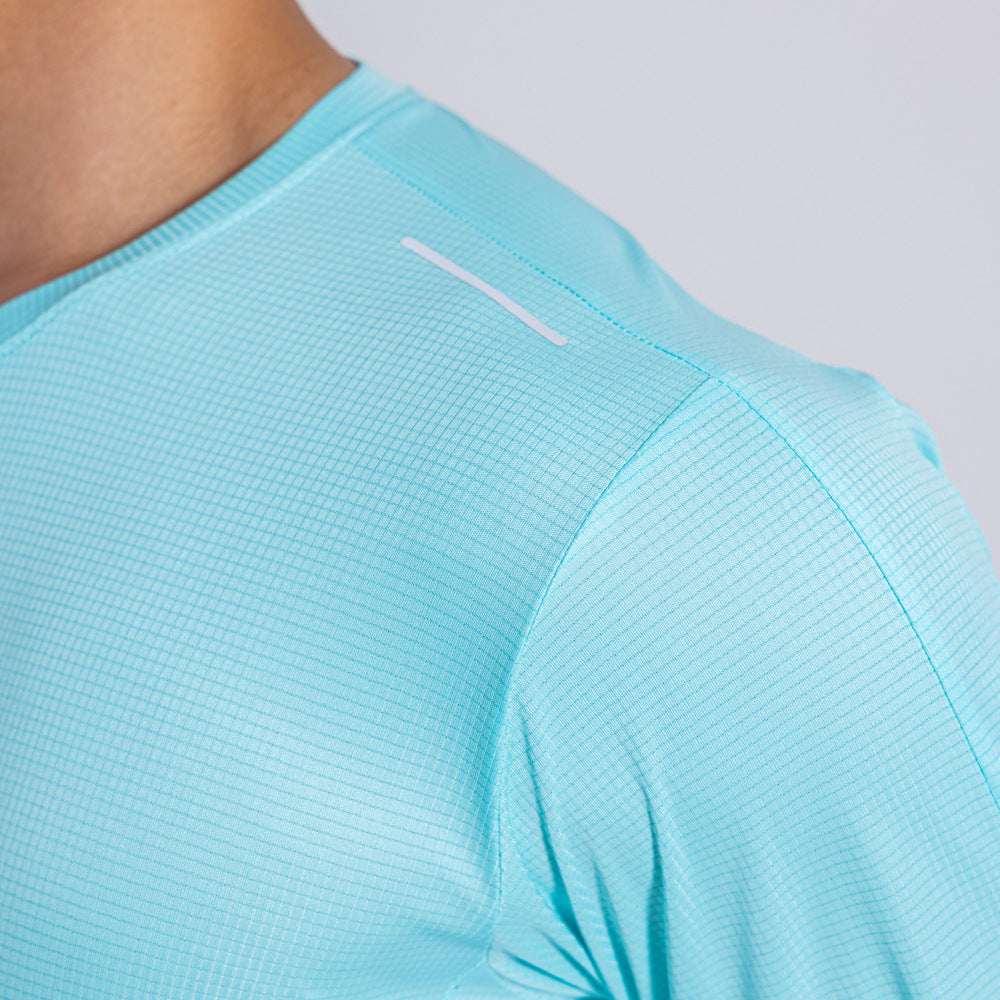 Close-up of a light blue athletic shirt with a brand logo on a plain background