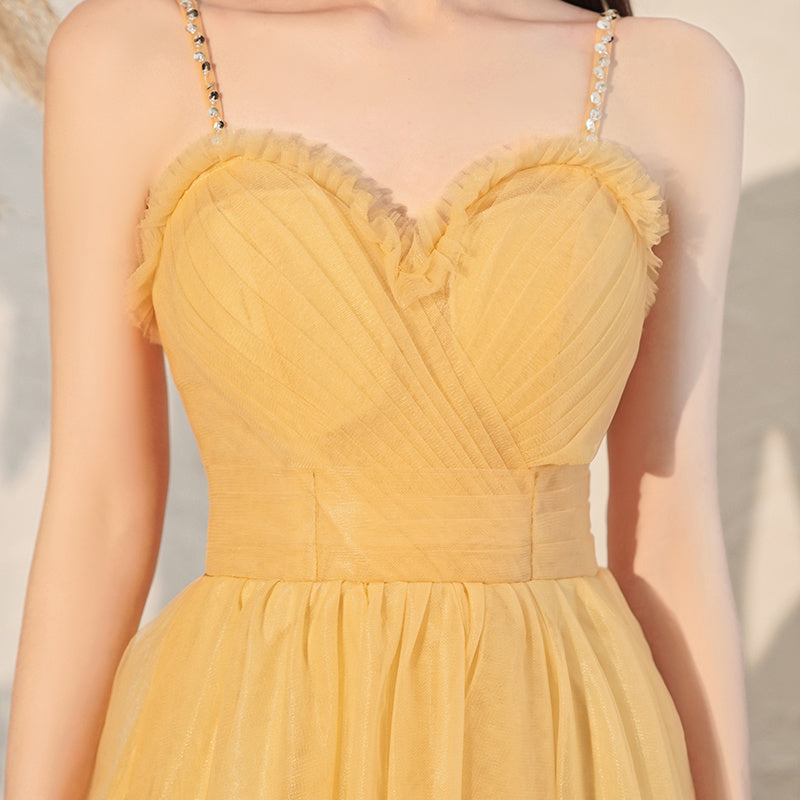 Yellow dress with floral details on a neutral background