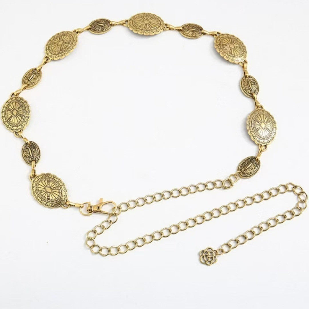 Gold chain belt with decorative elements on a white background