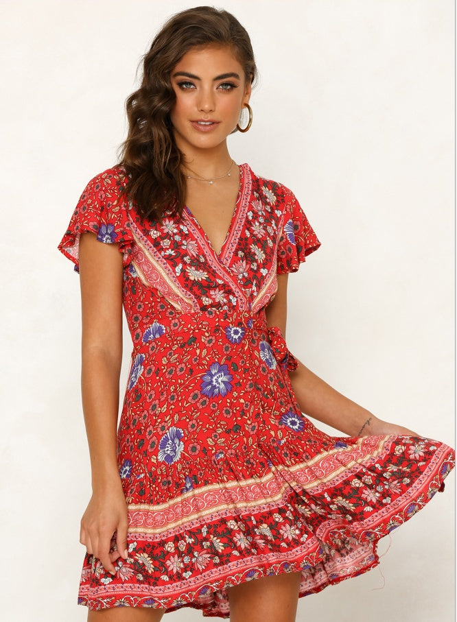Woman wearing a red floral dress on a white background