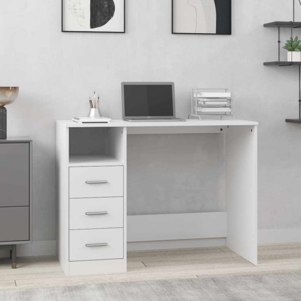 White desk with laptop and office supplies in a room with gray walls and a cabinet.