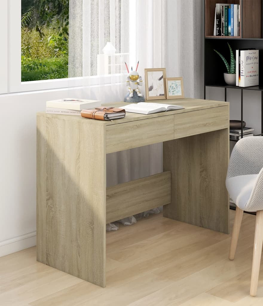 Wooden desk in a home office setting with a chair and decor items.