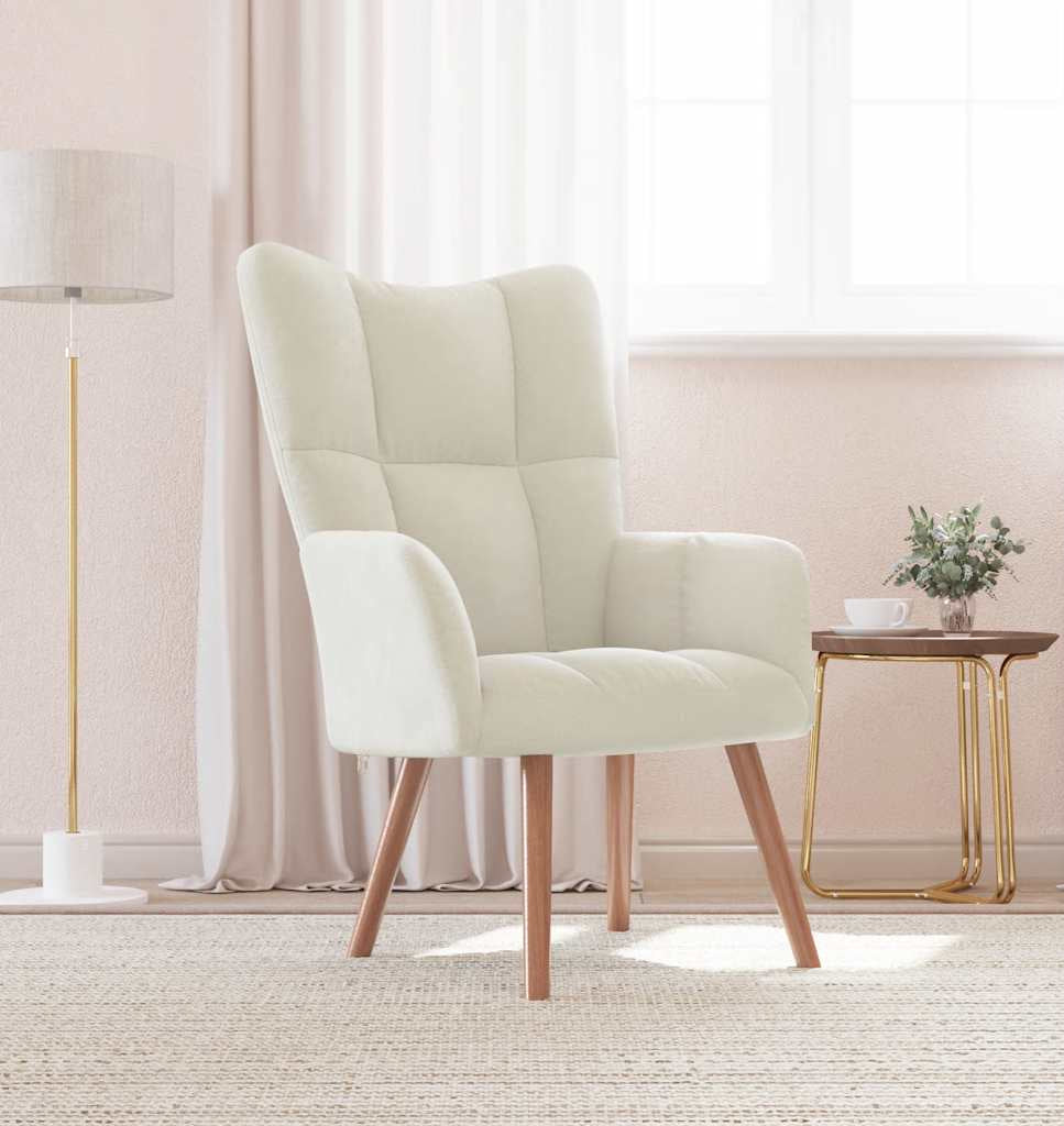 Beige armchair in a room with a lamp and small table with a plant.