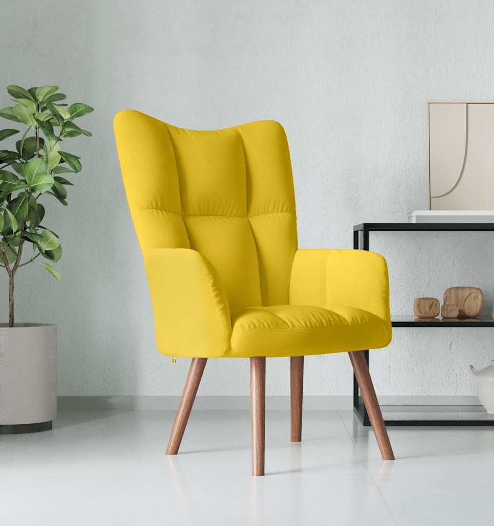 Yellow armchair in a modern living room setting with a plant and decorative items.