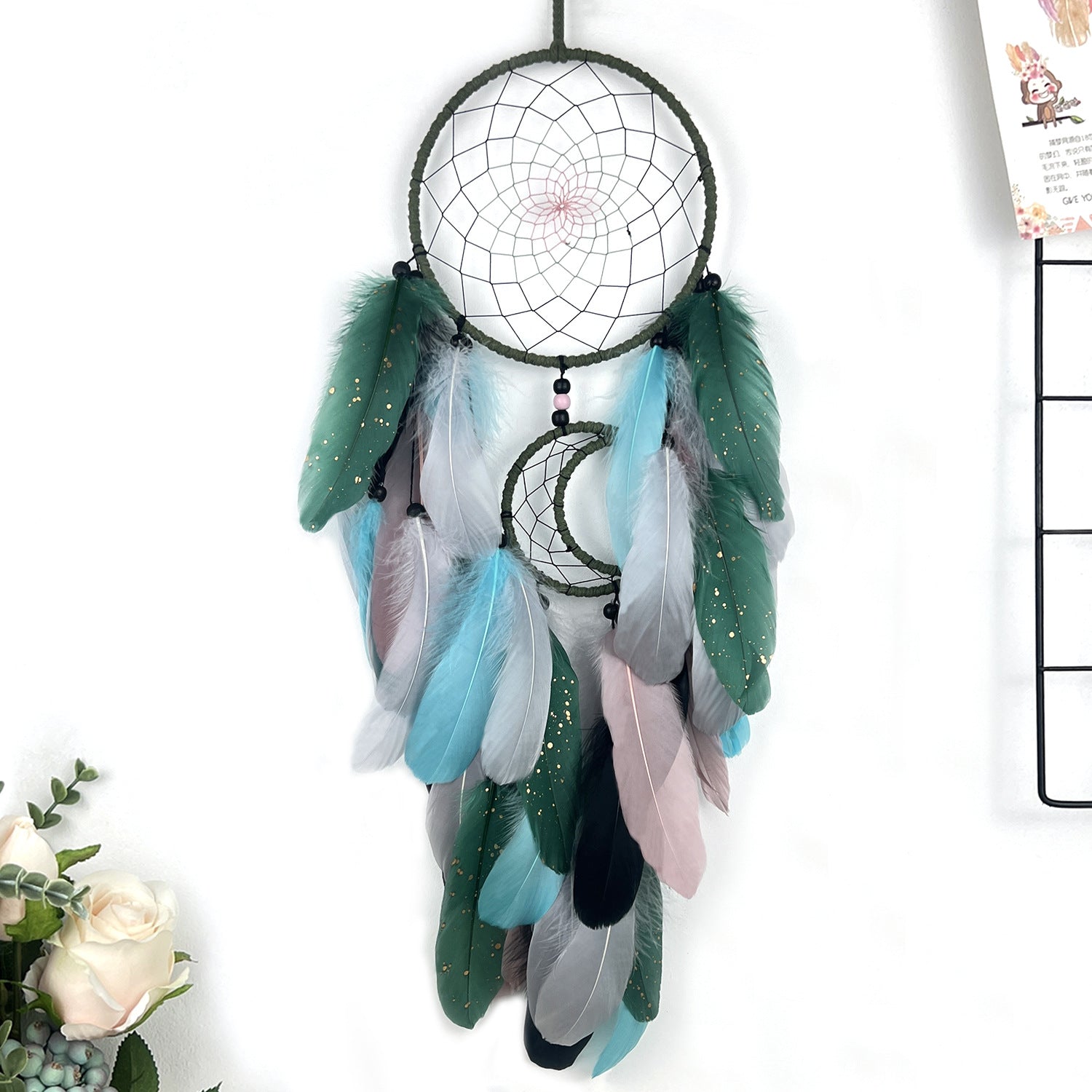 Dreamcatcher with feathers on a white background