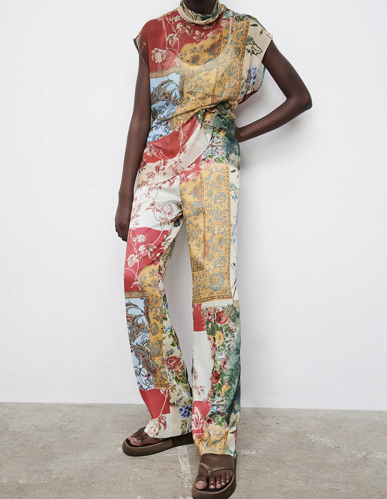 Person wearing a colorful patchwork outfit with a patterned scarf on a white background