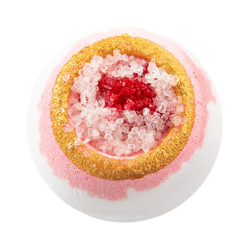 Multicolored bath bomb with a layered structure on a white background