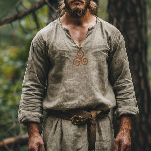 Man in historical attire standing in a forest