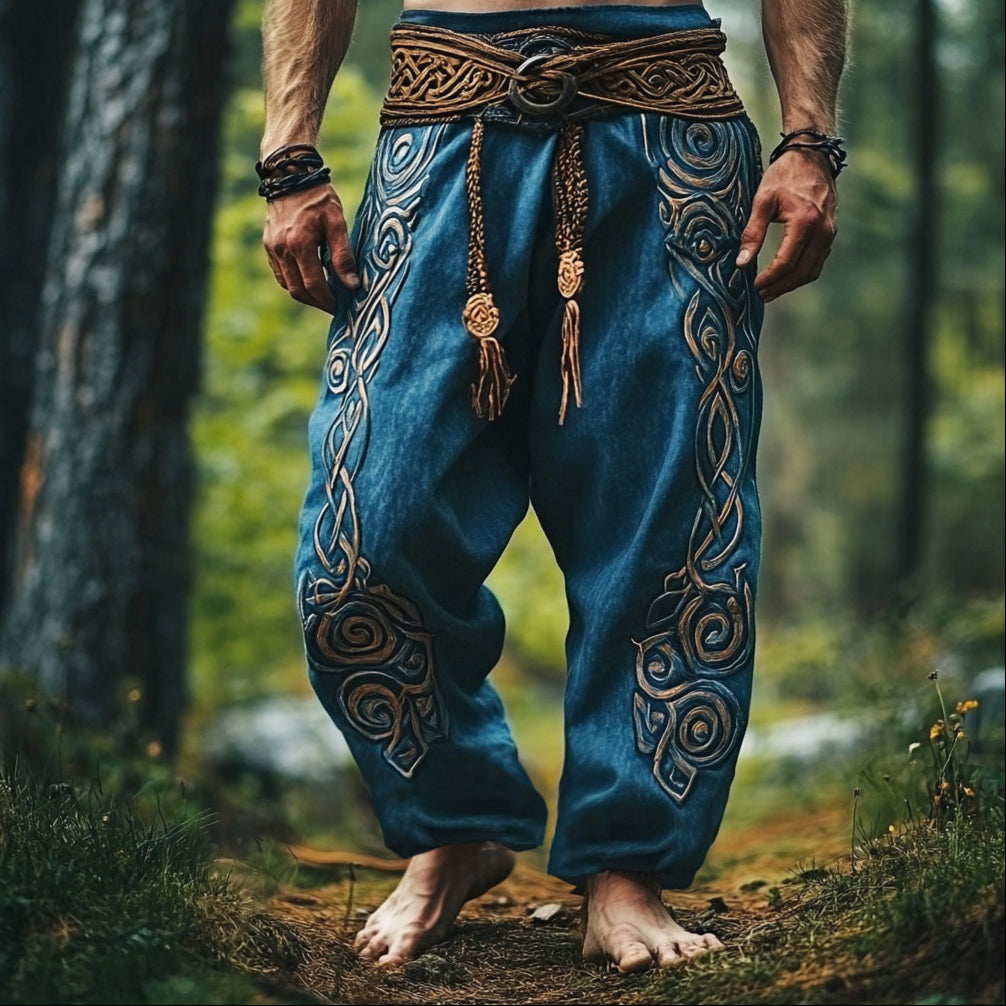 Person wearing blue pants with intricate patterns in a forest setting