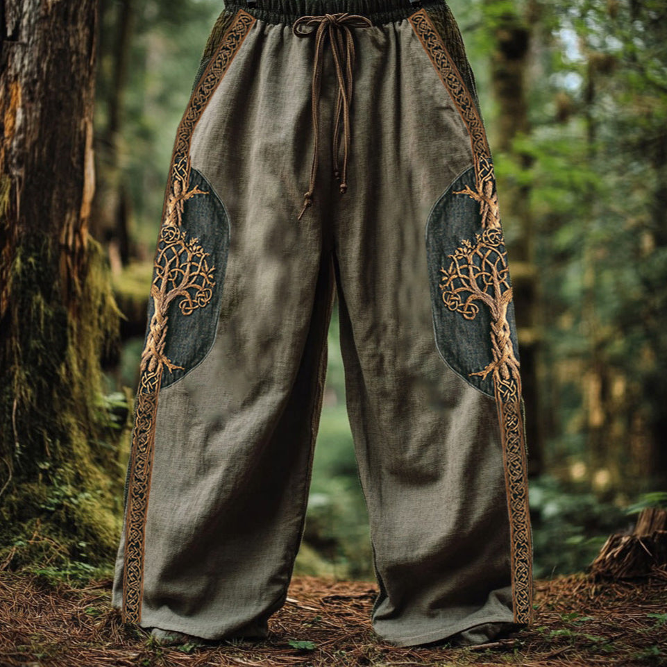 Traditional-style pants with tree designs in a forest setting