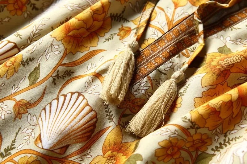 Decorative fabric with floral patterns and tassels on a matching background