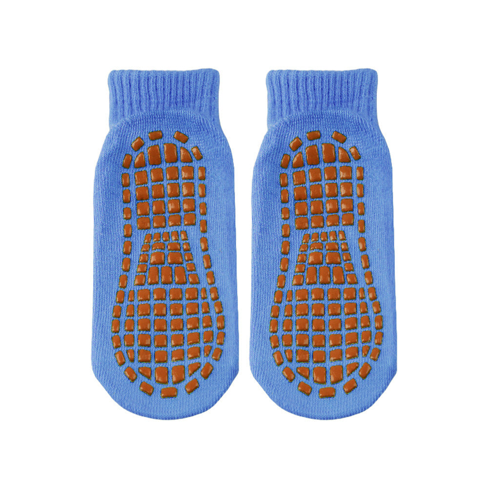 Pair of blue socks with brown textured sole on a white background