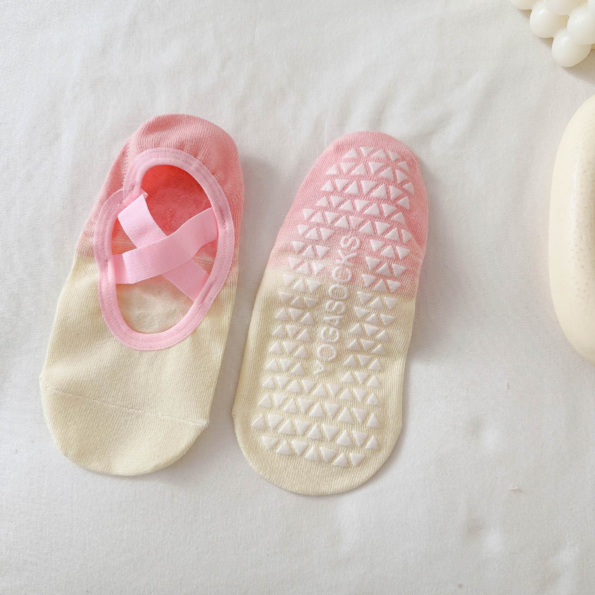 Pair of pink and beige socks with a visible brand logo on a light background