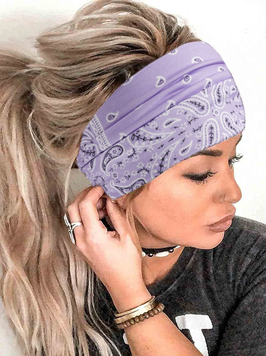 Woman wearing a purple bandana headband with a white background