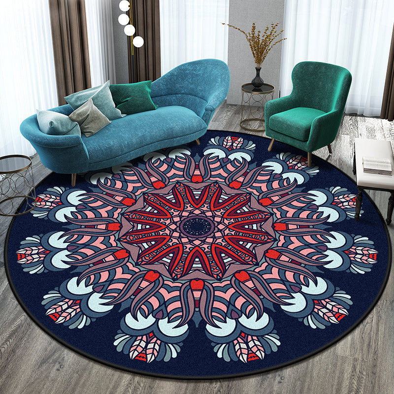 Round mandala rug with blue, red, and white colors in a living room setting.