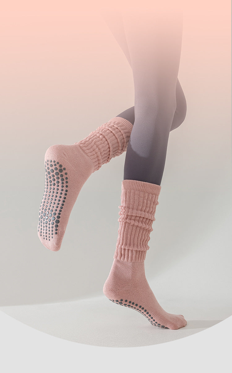 Person wearing pink socks with black dots on a light background