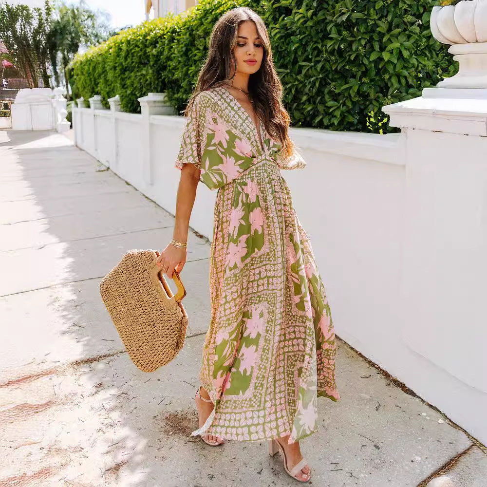Woman in a floral dress holding a straw bag on a sunny day.
