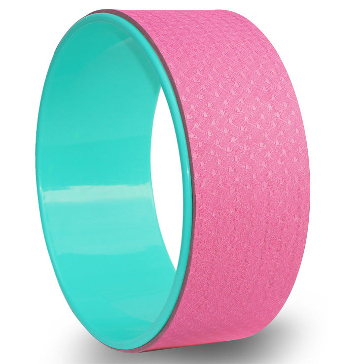 Pink and teal yoga wheel on a white background