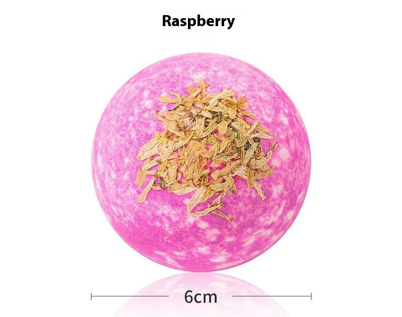 Pink bath bomb with dried herbs on a white background, labeled 'Bath Bombs Raspberry'.