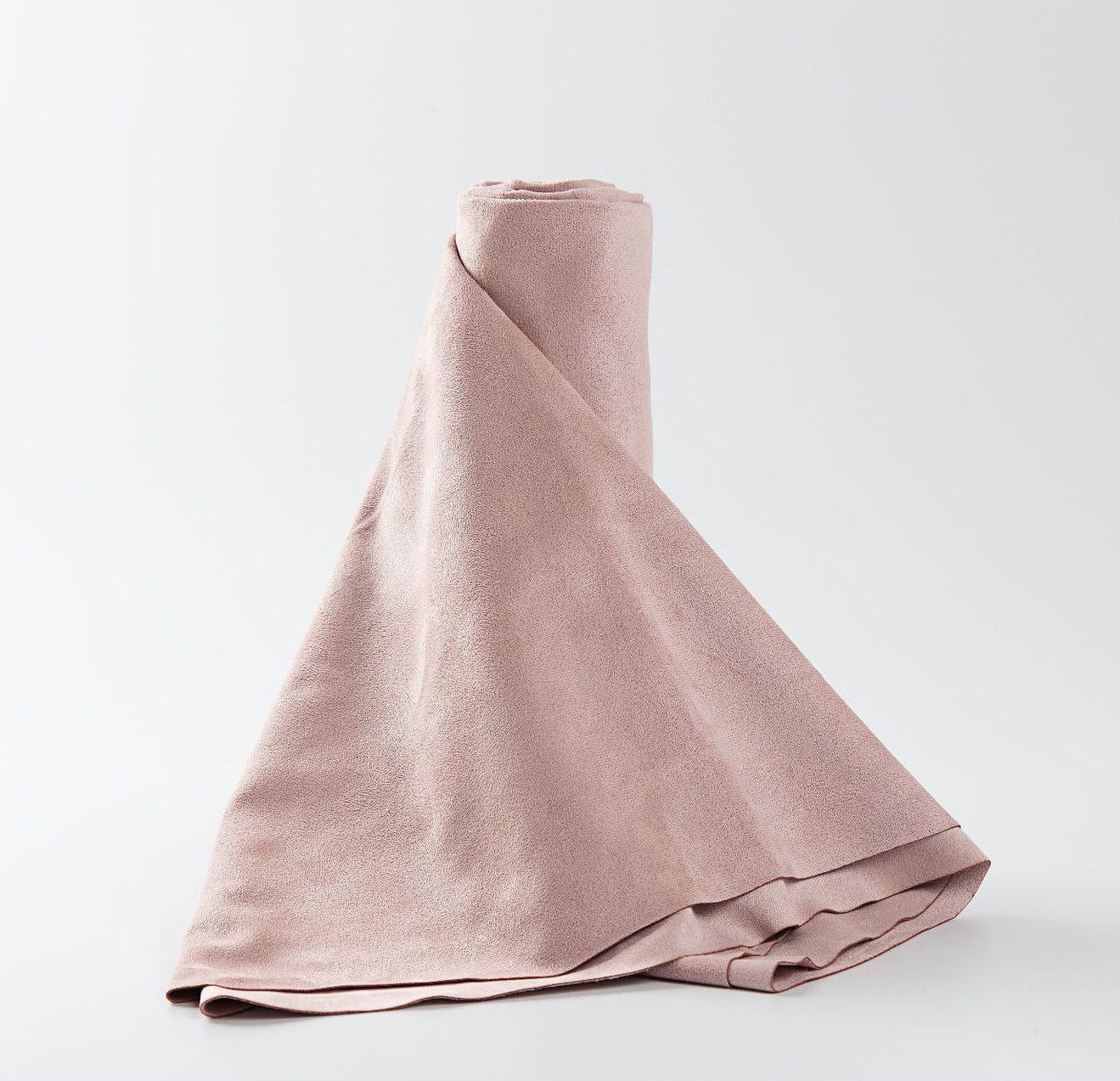 Pink fabric draped over a white background