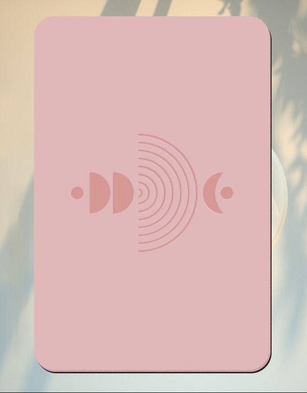 Pink product with a symbol on a background of a soft pink sky with mist at sunset