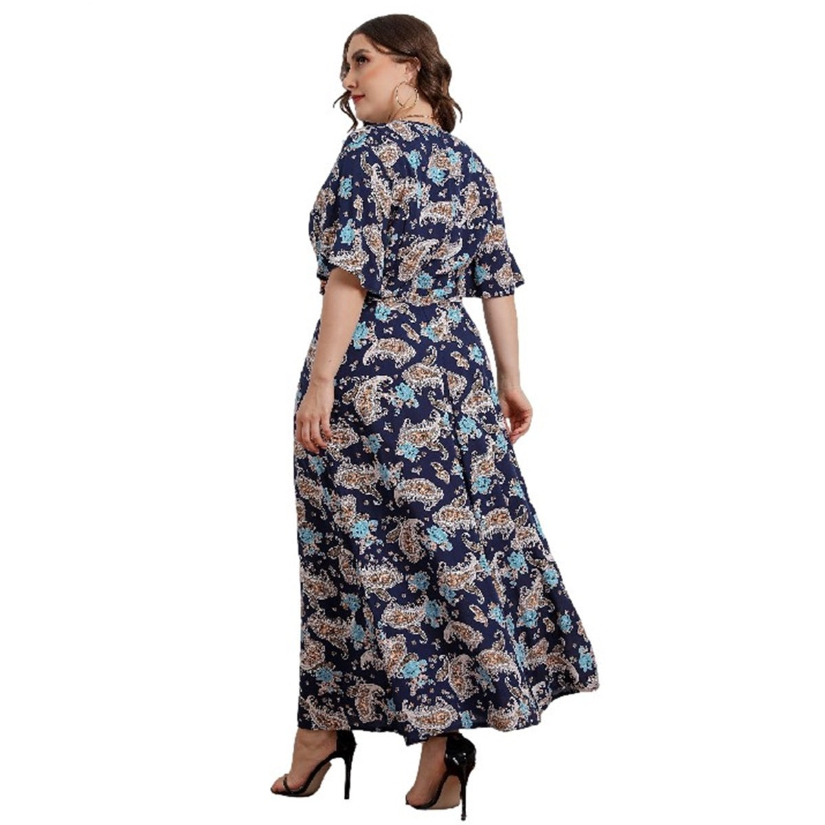 Woman wearing a navy floral dress on a white background