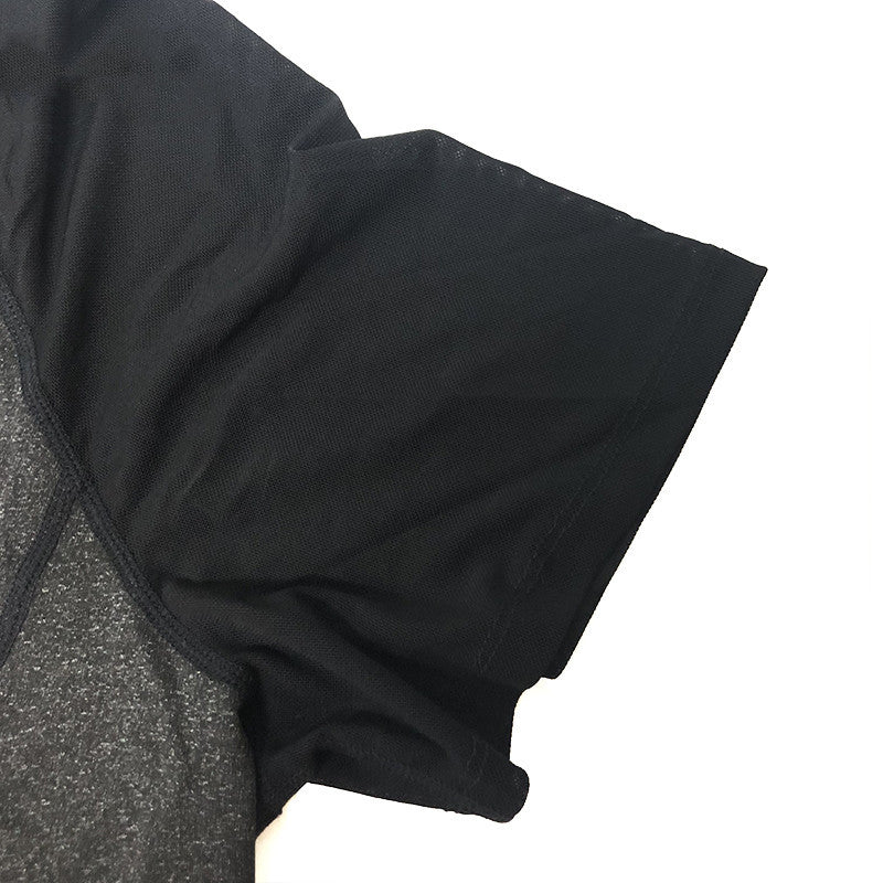 Close-up of a black sleeve on a gray garment with a white background