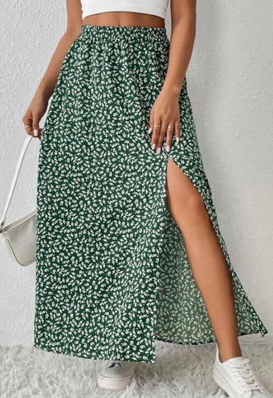 Green floral skirt with a side slit worn by a person on a white background