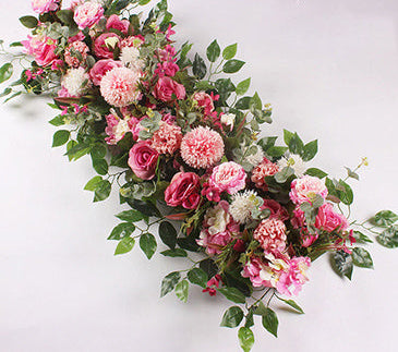 Floral arrangement with pink and green flowers on a white background