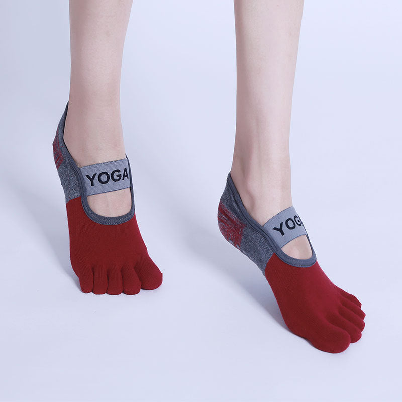 Red yoga socks with gray accents on a white background